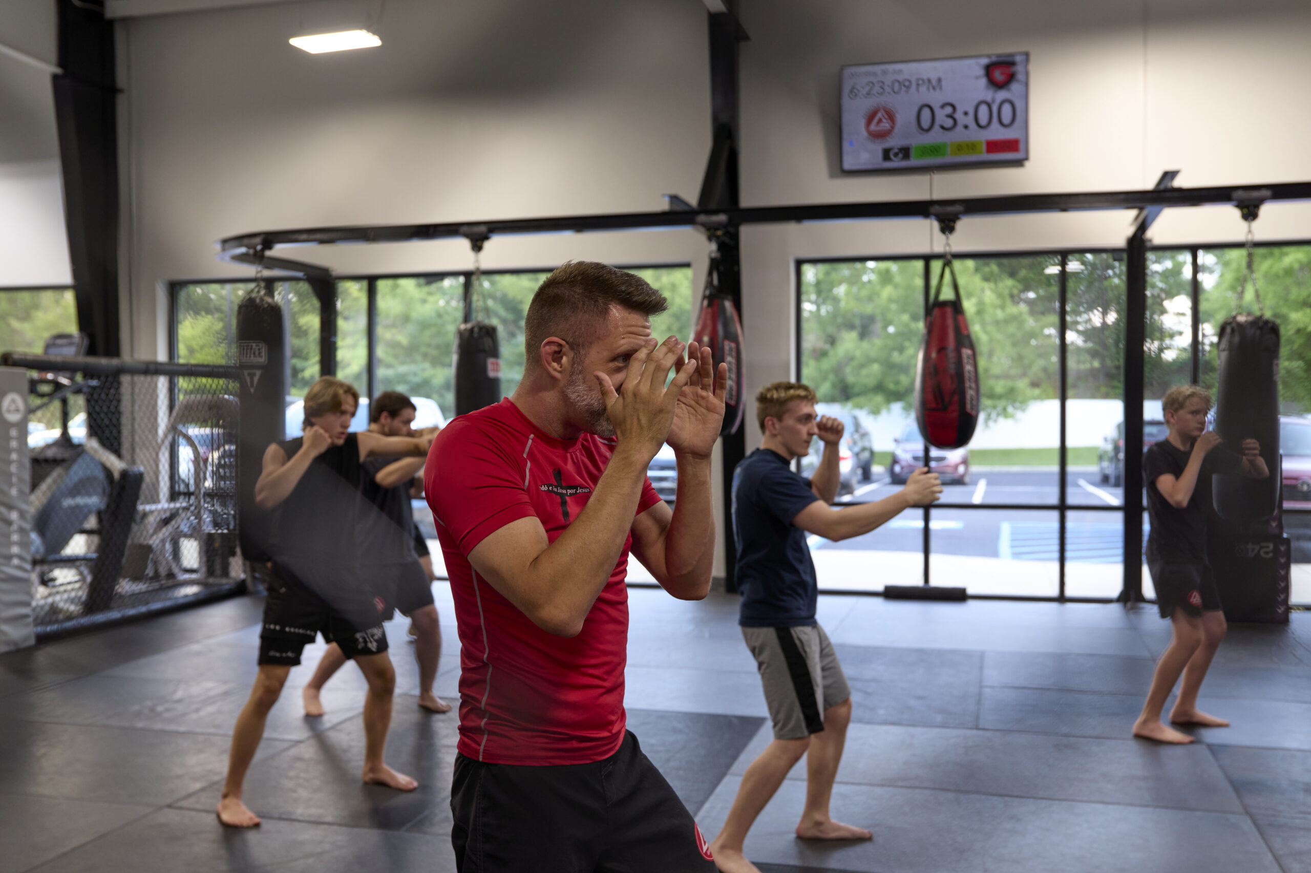 Gracie Barra Pelham student drilling Brazilian Jiu-Jitsu ground control techniques on the mat